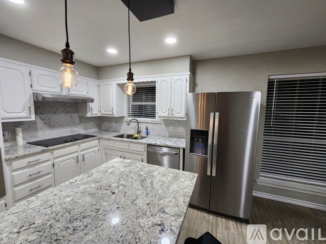 A kitchen with granite countertops and stainless steel appliances.