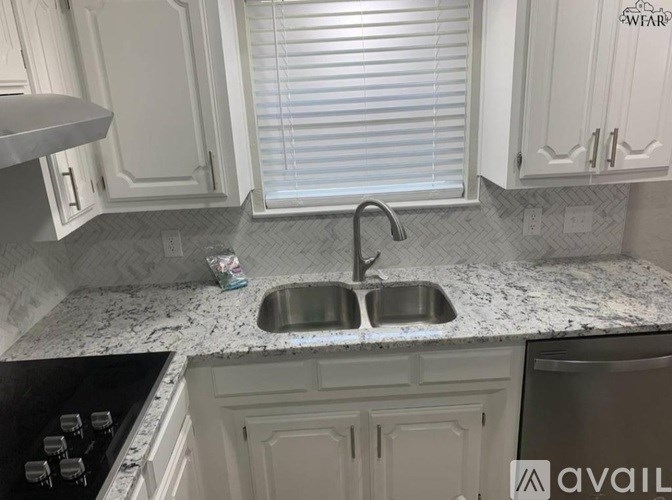 A kitchen with a sink and a window.