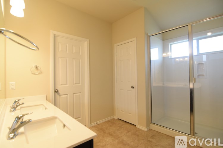 A bathroom with a sink, mirror, and two doors.