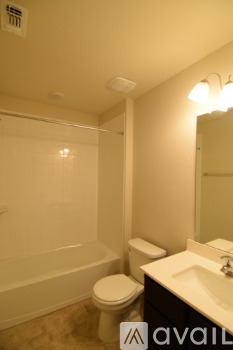 A bathroom with a toilet, sink, and bathtub.