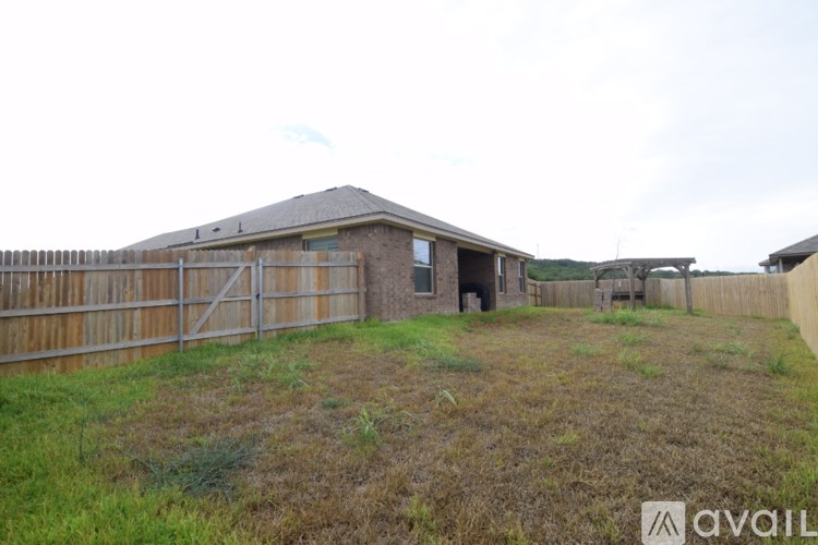 A house with a fence and a grassy yard.