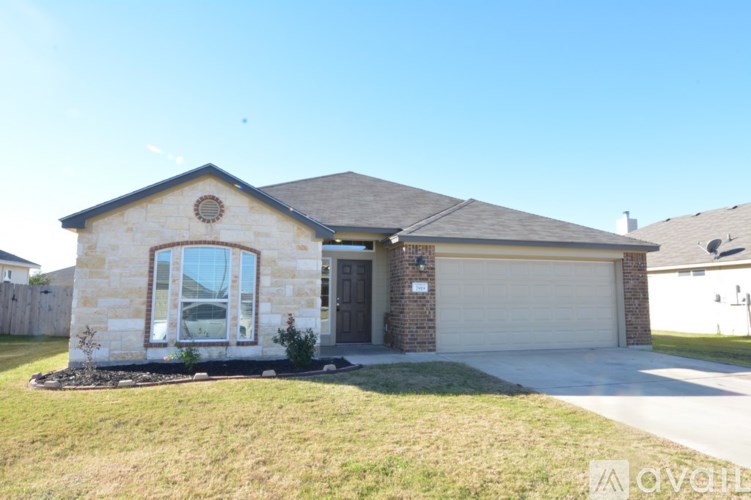 A house with a garage door and a window is shown.