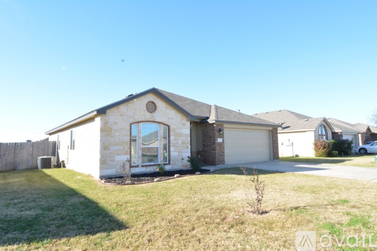 A house with a garage and a driveway is for sale.