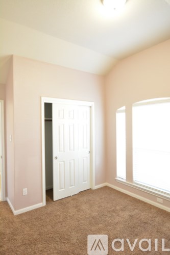 A room with a carpeted floor and a white door.