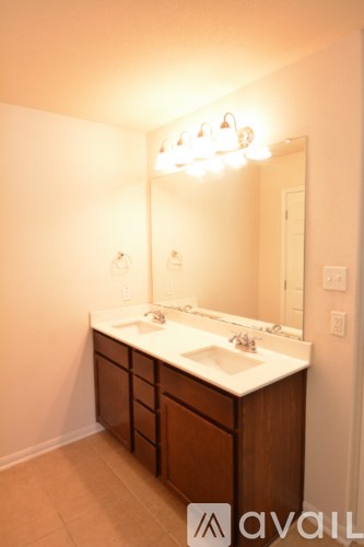 A bathroom with a vanity and a mirror.
