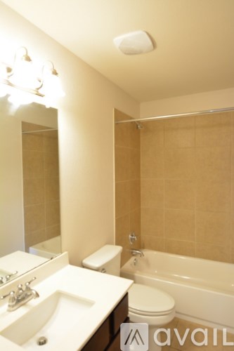 A bathroom with a toilet, sink, and bathtub.