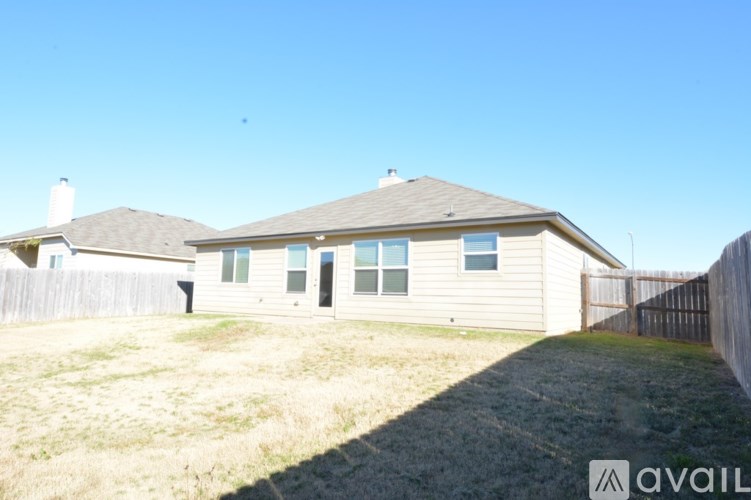 A house with a fence and a grassy yard.