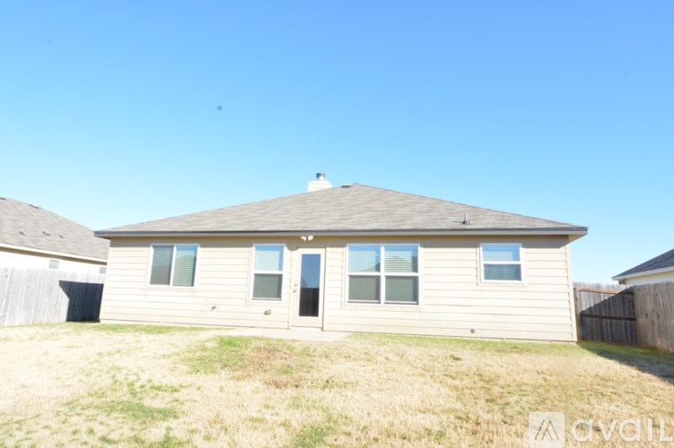 A house with a brown roof and a white door is for sale.