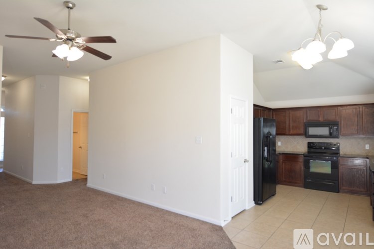 A living room with a kitchen in the background.