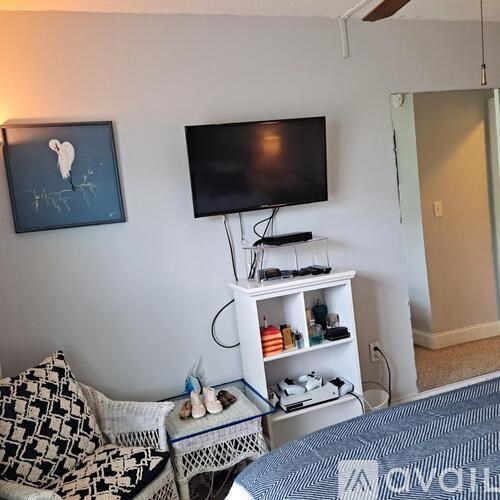 A living room with a television, a sofa, and a coffee table.
