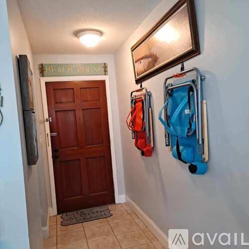 A hallway with a brown door and a sign that says "Break Room".