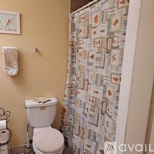 A toilet with a towel on top of it.