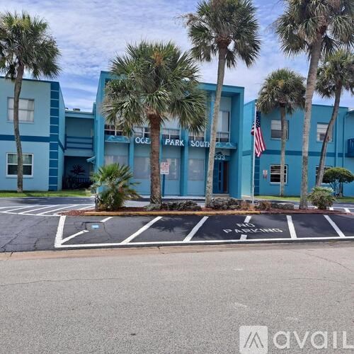 A parking lot in front of a building with a sign that says "OCE PARK SOUTH".