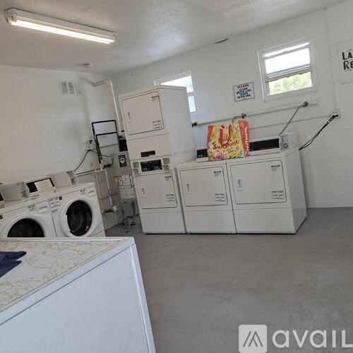 A laundry room with washers and dryers.