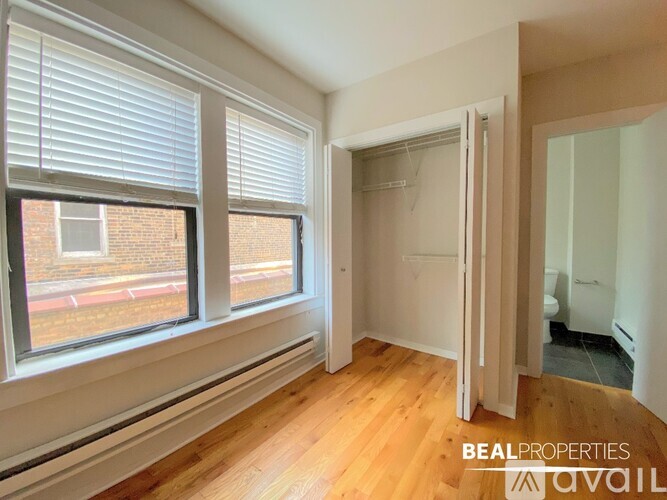 A room with a window and wooden floors is on the market through Beal Properties.