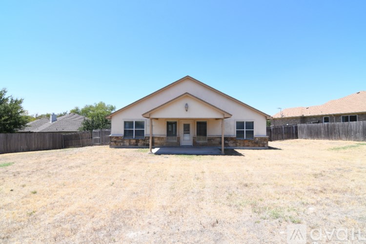 A house with a front yard and a fence.