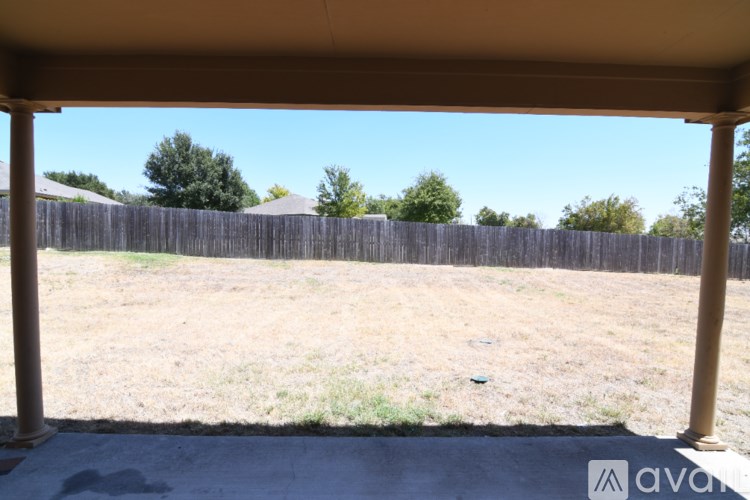 A patio with a wooden fence in the background.
