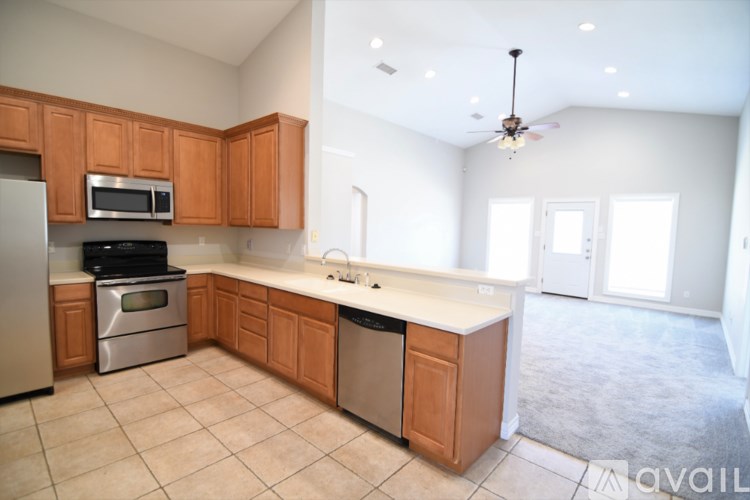A kitchen with wooden cabinets and a tiled floor.