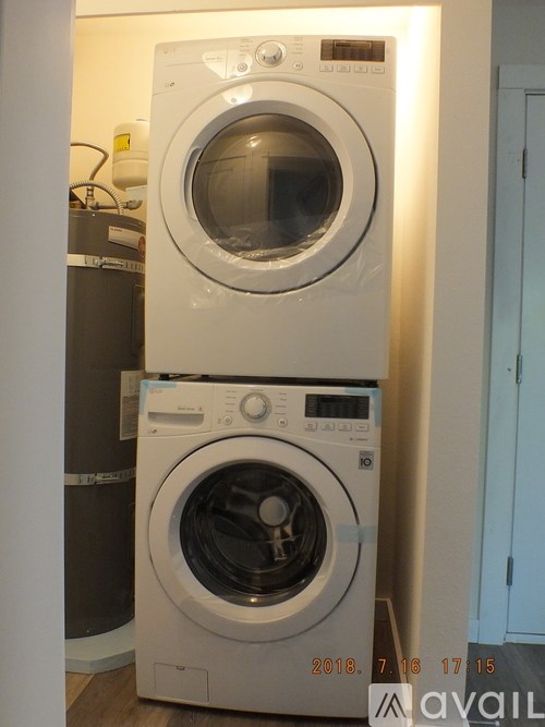 A white dryer and washer from 2018 are stacked on top of each other.