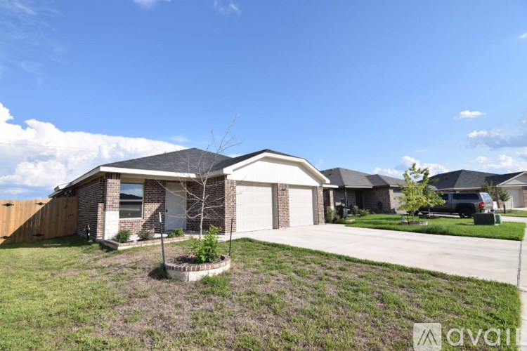 A house with a white garage door and a brown roof.
