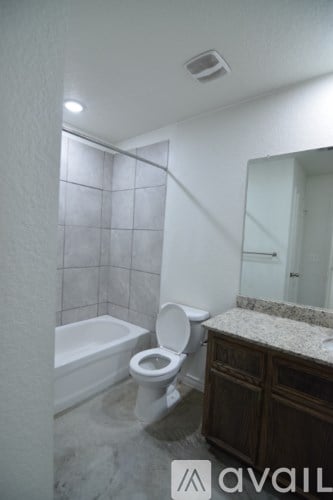 A bathroom with a toilet, sink, and bathtub.