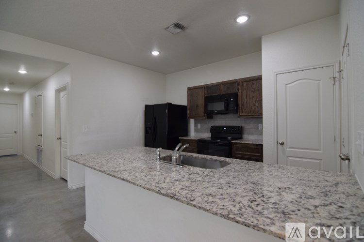 A kitchen with granite countertops and a sink.
