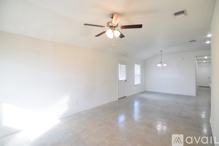 A spacious room with a ceiling fan and lighting fixture.