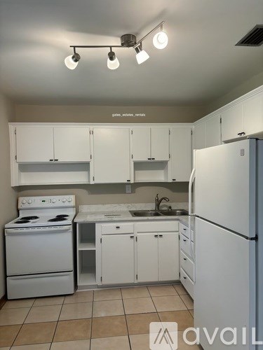A kitchen with white appliances and cabinets.