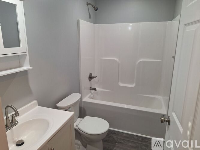 A white toilet sits next to a sink in a bathroom.