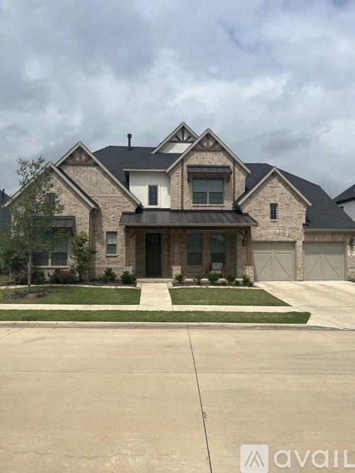 A large house with a driveway in front.