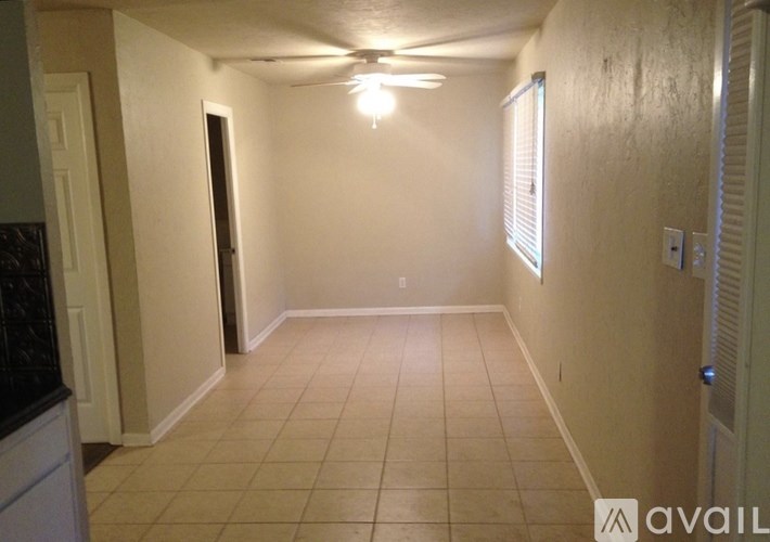 A room with a tiled floor and a ceiling fan.