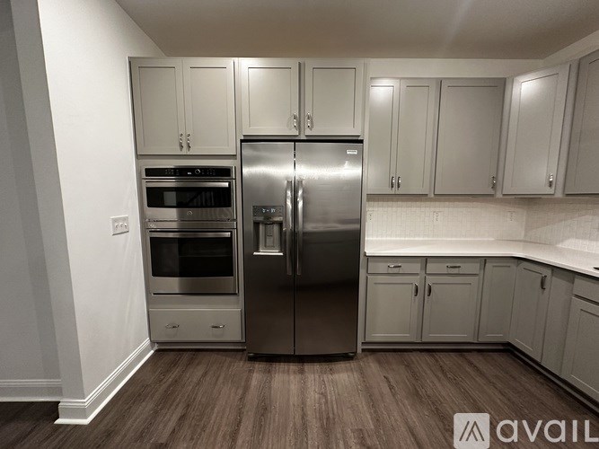 A kitchen with a stainless steel refrigerator and oven.