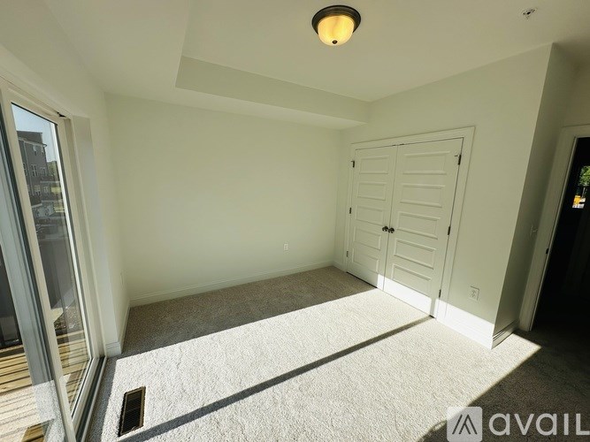 A room with a carpeted floor and a ceiling light.