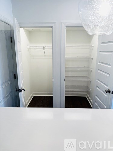 A white interior with a chandelier and a logo that reads "avail".