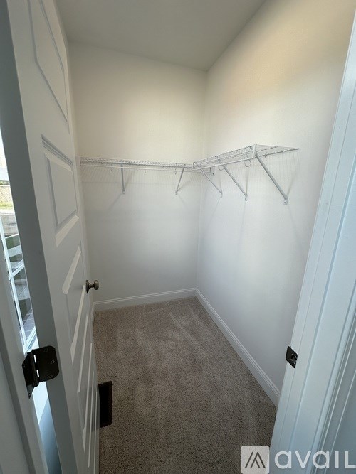 A white closet with a coat hanger.