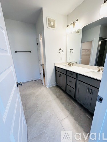 A bathroom with a white sink and a mirror.