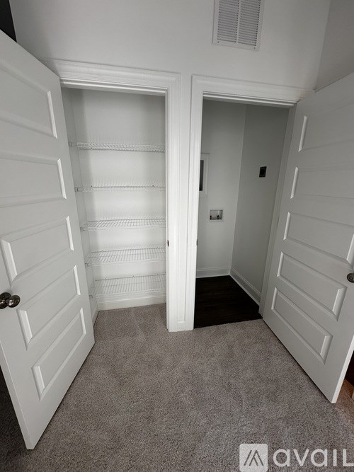 A white door with a black handle is open.