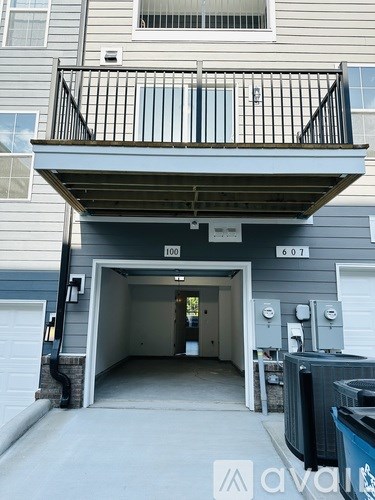 A balcony with a railing is on the second floor of a building.