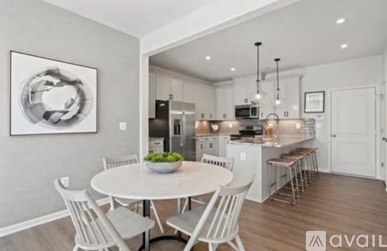 A modern kitchen with a dining table and chairs.