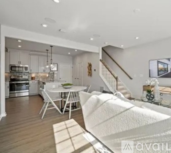 A modern kitchen with a dining table and chairs.