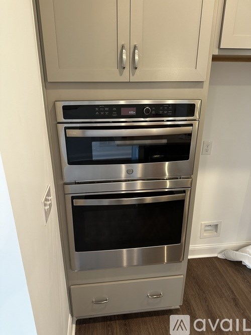 A stainless steel double oven built into a kitchen cabinet.