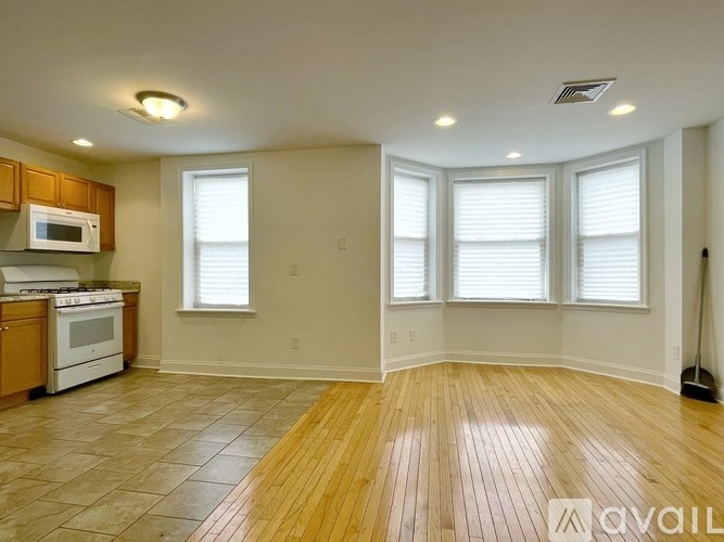 A kitchen with wooden cabinets and a white stove top oven.