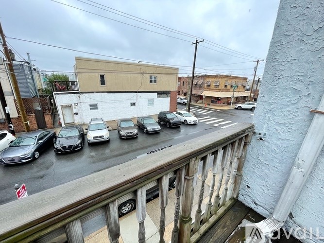 Cars parked on a street next to a building.