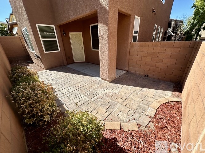 A house with a red brick wall and a yellow door.