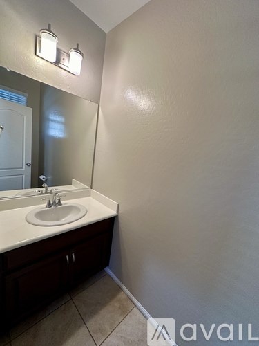 A bathroom with a sink and mirror.