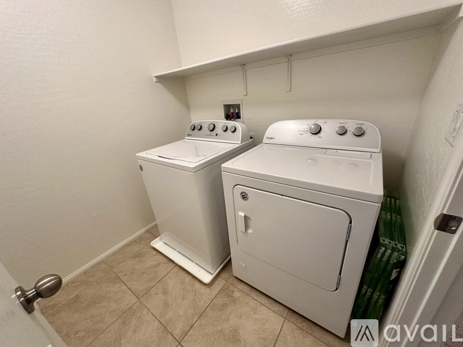 A white washer and dryer in a small laundry room.