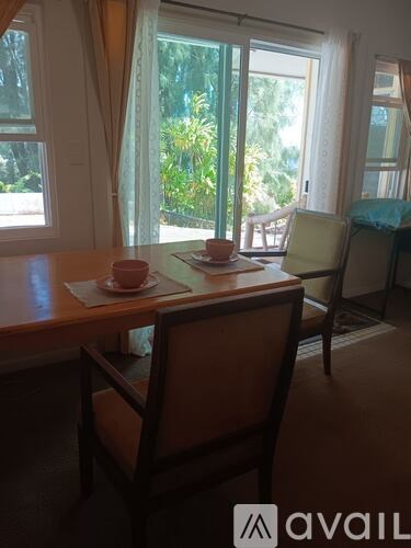 A table with two chairs and a cup on it.