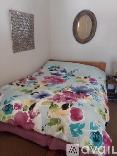 A bed with a floral print is in the image.