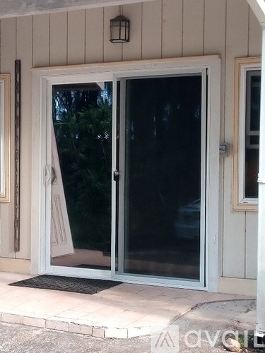 A glass door with a black mat in front of it.