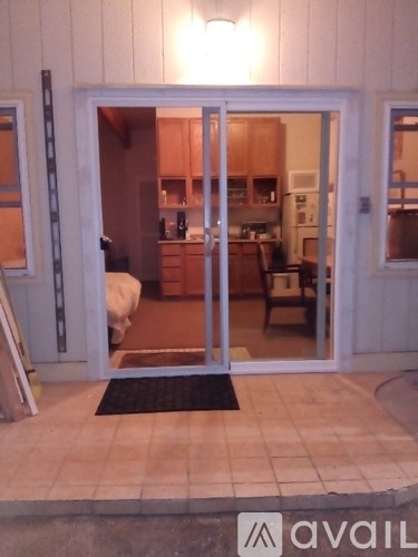 A glass door leading to a kitchen.